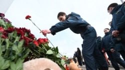 Russian Emergency Ministry cadets lay flowers at a makeshift memorial in front of the burnt-out Crocus City Hall concert venue in Krasnogorsk, outside Moscow, on March 26, 2024.