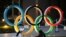 Olympic rings are seen near the National Stadium in Tokyo. Japan is publicly adamant that it will stage its postponed Olympics this summer.