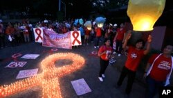 FILE - Filipinos release paper lanterns to mark World AIDS Day Dec. 1, 2012, at the Heroes Shrine at suburban Quezon city northeast of Manila, Philippines.