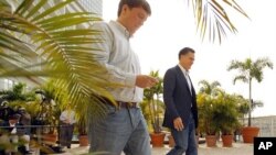 Republican presidential candidate and former Massachusetts Governor Mitt Romney and traveling press secretary Rick Gorka walk away after speaking to reporters in Tampa, January 23, 2012