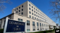 File - The Harry S. Truman Building, headquarters for the State Department, is seen in Washington, in this March 9, 2009 file photo. A retired State Department worker, Walter Kendall Myers and his wife Gwendolyn Steingraber Myers, have been…