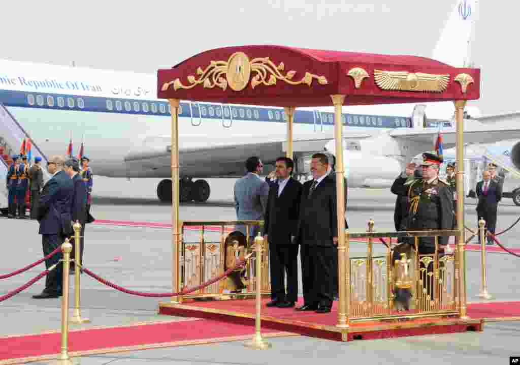 Iran's President Mahmoud Ahmadinejad and Egyptian President Mohamed Morsi participate in an arrival ceremony at the airport in Cairo, Egypt, February 5, 2013. (Egyptian Presidency Handout)