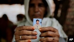 Kareeman Bano holds a photograph of her son-in-law Rakbar Khan, who was killed by a mob on suspicion of cattle smuggling, in Kolgaon village, India, July 24, 2018. Mob attacks on minority groups have occurred since the Hindu nationalist BJP swept elections in 2014.