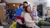 Steve Petersen, second from left, his wife Jennifer, and their children Jerrik, left, and Carolynn, are photographed at their two-bedroom apartment in Campbell, California, Jan. 15, 2025. 