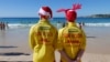 FILE - Volunteer life guards from North Bondi Surf Life Saving Club, keep an eye on swimmers enjoying Christmas day on Bondi Beach, Sydney, Dec. 25, 2018. Australia sweated through one of its hottest Decembers ever, and January wasn't any better.