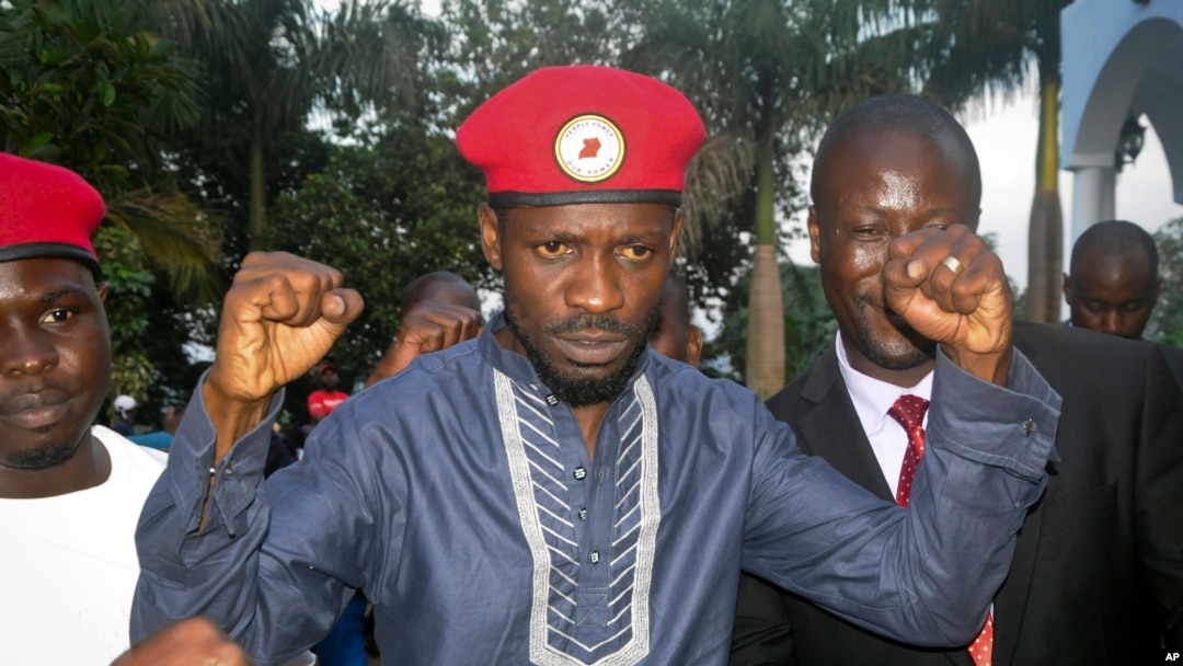 FILE - Ugandan pop star and opposition figure Bobi Wine greets his followers as he arrives home after being released from prison on bail in Kampala, May 2, 2019. 