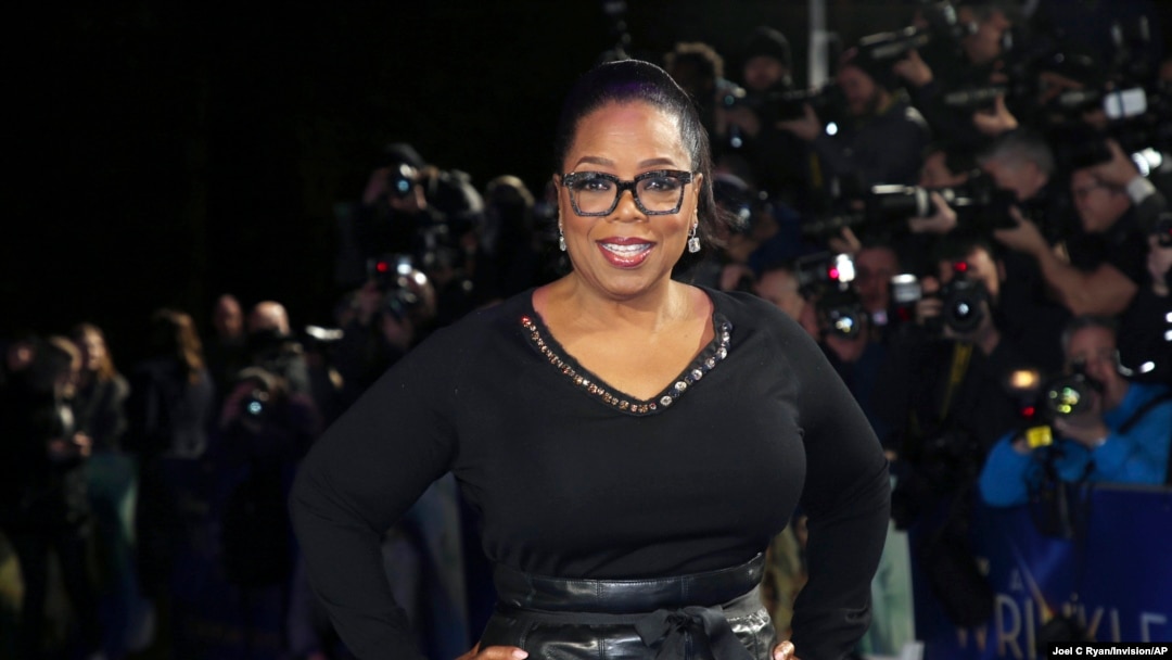 FILE - Oprah Winfrey poses for photographers upon arrival at a film premiere in London, Britain, March 13, 2018.