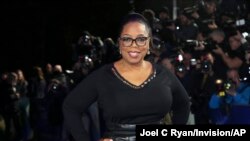 FILE - Oprah Winfrey poses for photographers upon arrival at a film premiere in London, Britain, March 13, 2018.