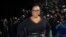 FILE - Oprah Winfrey poses for photographers upon arrival at a film premiere in London, Britain, March 13, 2018.