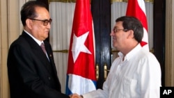 North Korea's Foreign Minister Ri Su Yong, left, shakes hands with Cuba's Foreign Minister Bruno Rodriguez during a photo opportunity before their meeting in Havana, Cuba, March 16, 2015.