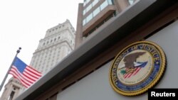 FILE - The seal of the United States Department of Justice is seen on the building exterior of the United States Attorney's Office of the Southern District of New York in Manhattan, New York City, Aug. 17, 2020.