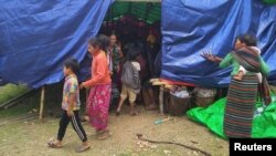 FILE - People displaced by fighting in northwestern Myanmar between junta forces and anti-junta fighters are seen at a camp in Chin state, Myanmar, May 31, 2021. 