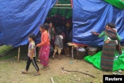 FILE - People displaced by fighting in northwestern Myanmar between junta forces and anti-junta fighters are seen at a camp in Chin state, Myanmar, May 31, 2021.