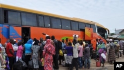 FILE - People board a commercial bus to flee following attacks by Boko haram in Bama and other parts of Maiduguri, Nigeria, Sept. 8, 2014. 