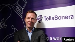 FILE - TeliaSonera Chief Executive Johan Dennelind poses for a picture at the Mobile World Congress in Barcelona, Feb. 25, 2014. 