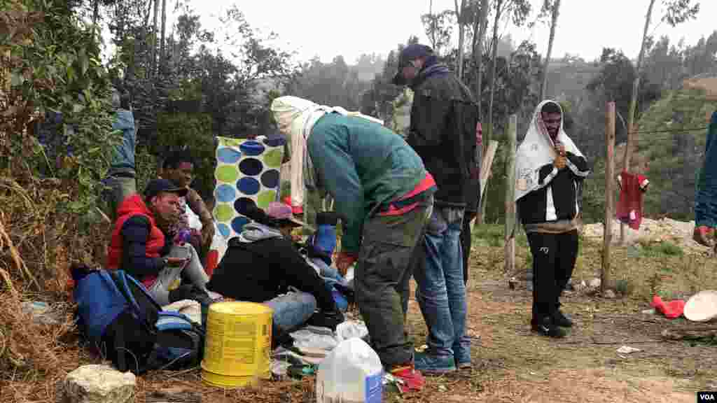 Un grupo de venezolanos espera&nbsp;mientras la frontera para Ecuador abre para ellos, tratan de mantenerse abrigados en medio del frío y se ayudan para poder comer. Ipiales, Colombia, 11 de septiembre de 2019.&nbsp; Foto: Celia Mendoza - VOA. 