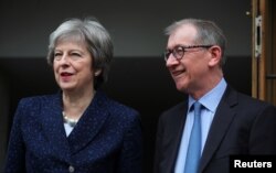 Britain's Prime Minister Theresa May and her husband, Philip, leave after voting in local government elections in London, May 3, 2018.