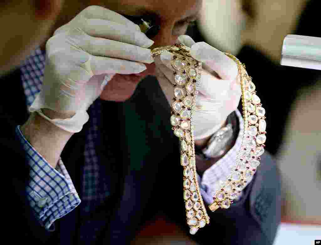 Christie's auction house appraiser David Warren examines a set of jewelry from Roumeliotes Collection, one of three sets of the Marcos Jewelry Collection, during appraisal at the Central Bank of the Philippines in Manila. The Philippine government is having millions of dollars’ worth of jewelry seized from former First Lady Imelda Marcos appraised ahead of a possible auctioning of the collection. The jewelry was seized when Marcos’ family fled to Hawaii in 1986 following a revolt that ended her husband’s two decades in power.