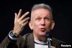 Jean Paul Gaultier gestures as he attends a news conference before the press visit of the Jean Paul Gaultier Exhibition at the Grand Palais, March 30, 2015.