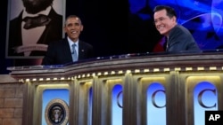 President Barack Obama talks with Stephen Colbert of "The Colbert Report" during a taping of The Colbert Report program in Lisner Auditorium at George Washington University in Washington, Dec. 8, 2014.