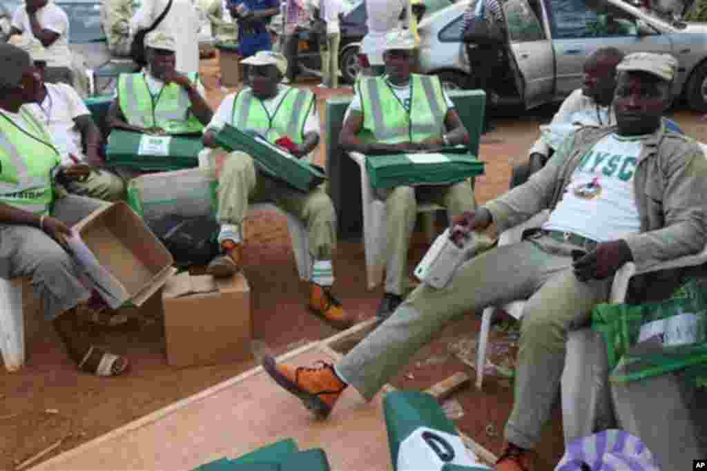 Electoral officials wait for ballot material at the distribution centre in Ibadan, Nigeria, Saturday, April 2, 2011. The first election in a month of voting across oil-rich Nigeria starts Saturday as election workers counted ballot papers and voters wait