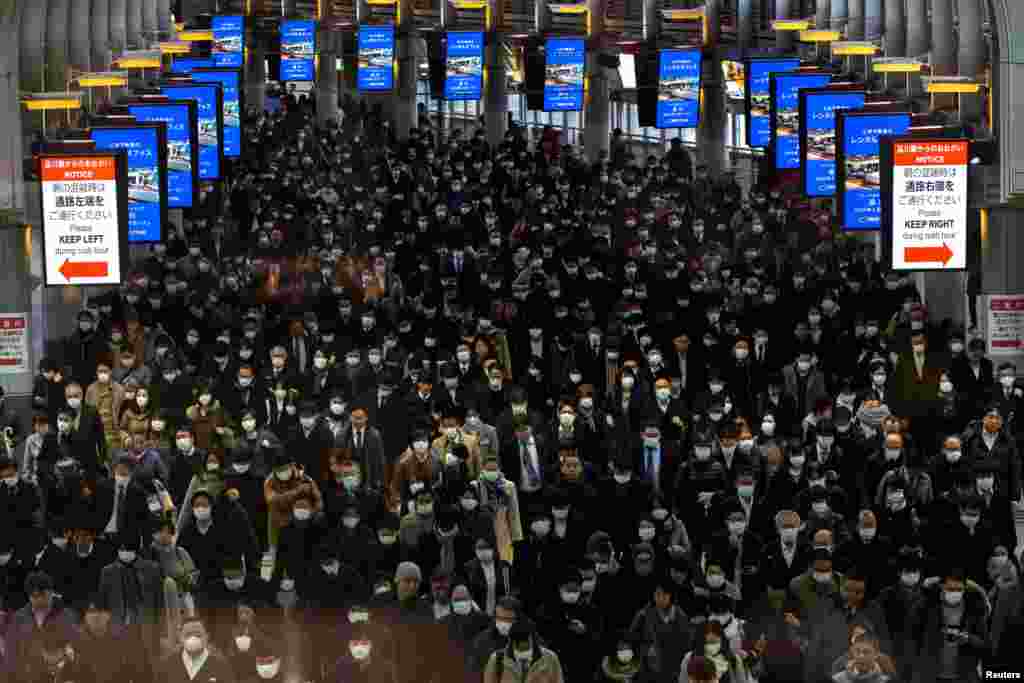 Crowds wearing protective masks, following an outbreak of the coronavirus, are seen at the Shinagawa station in Tokyo, Japan.