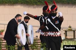 U.S. Secretary of State Mike Pompeo and U.S. Secretary of Defence Mark Esper lay wreaths at the National War Memorial in New Delhi, India, Oct. 27, 2020.