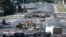 A street is blocked by debris and burnt items following overnight unrest in the Magenta district of Noumea in France's Pacific territory of New Caledonia on May 18, 2024.
