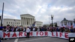 Participants in the annual March for Life pose in front of the U.S. Supreme Court in Washington, Jan. 24, 2025.