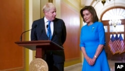 Britain's Prime Minister Boris Johnson, left, is welcomed to the U.S. Capitol in Washington by Speaker of the House Nancy Pelosi, D-Calif., Sept. 22, 2021. 