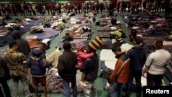 Migrants from Central America line up for food at an improvised shelter in Ciudad Juarez, Mexico Feb. 21, 2019. 