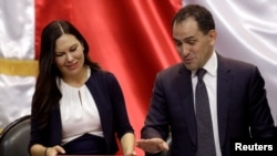 Mexico's Finance Minister Arturo Herrera presents the 2020 national budget to Laura Angelica Rojas, president of the Lower House of Congress, at the Congress building in Mexico City, Mexico, Sept. 8, 2019. 