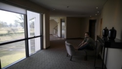 Dr. Juan José Comas looks out a window in a hall of his hotel in Buenos Aires, Argentina, Thursday, July 16, 2020. "My life goes from the hotel to the hospital. Even if you get along very well, you need your space. I go in front of the window to read or I go for a walk. Do not leave here, it burns you," he admits. (AP Photo/Natacha Pisarenko)