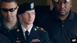 Army Pfc. Bradley Manning is escorted to a security vehicle outside a courthouse in Fort Meade, Md., Aug. 20, 2013, after a hearing in his court martial.