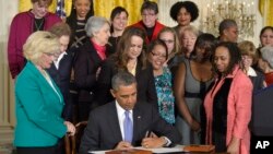 President Barack Obama signs executive actions, with pending Senate legislation, aimed at closing a compensation gender gap that favors men, Tuesday, April 8, 2014, in Washington, during an event marking Equal Pay Day.
