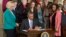 President Barack Obama signs executive actions aimed at closing a compensation gender gap that favors men, Tuesday, April 8, 2014.