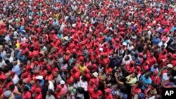 FILE: Supporters gather and listen to newly elected leader of the opposition Movement For Democtractic Change (MDC) party, Nelson Chamisa addressing them outside the party headquarters in Harare, Thursday, Feb, 15, 2018. 