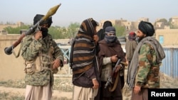 FILE - A group of Taliban fighters are seen in Ghazni province, Afghanistan, April 18, 2015.
