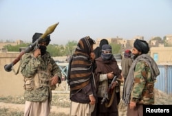 FILE - A group of Taliban fighters are seen in Ghazni province, Afghanistan, April 18, 2015.