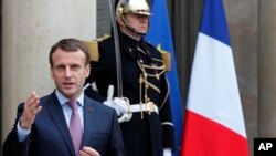 French President Emmanuel Macron arrives to adress reporters after a meeting with his Bulgarian counterpart Rumen Radev at the Elysee Palace, in Paris, France, Dec. 4, 2017. 