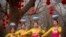 Dancers in traditional ethnic clothing perform at a temple fair at Longtan Park in Beijing, China. Chinese people are celebrating the second day of the Lunar New Year, the Year of the Pig on the Chinese zodiac.