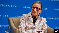 FILE - Supreme Court Justice Ruth Bader Ginsburg smiles as she takes questions from first-year students at Georgetown Law, Sept. 26, 2018, in Washington.