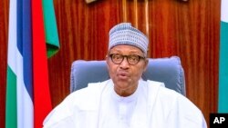 FILE - In this photo released by the Nigeria State House, Nigeria's President Muhammadu Buhari, addresses the nation on a live televised broadcast, Oct. 22, 2020.