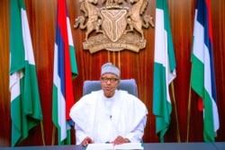 In this photo released by the Nigeria State House, Nigeria's President Muhammadu Buhari, addresses the nation on a live televised broadcast, Oct. 22, 2020.
