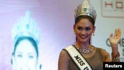 FILE - Miss Universe 2015 Pia Wurtzbach waves during a news conference at a hotel in Quezon city, metro Manila, Jan. 24, 2016, after her return to the Philippines. 