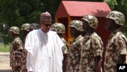 Nigerian President Muhammadu Buhari reviews troops in Maiduguri on Oct. 1, 2017.