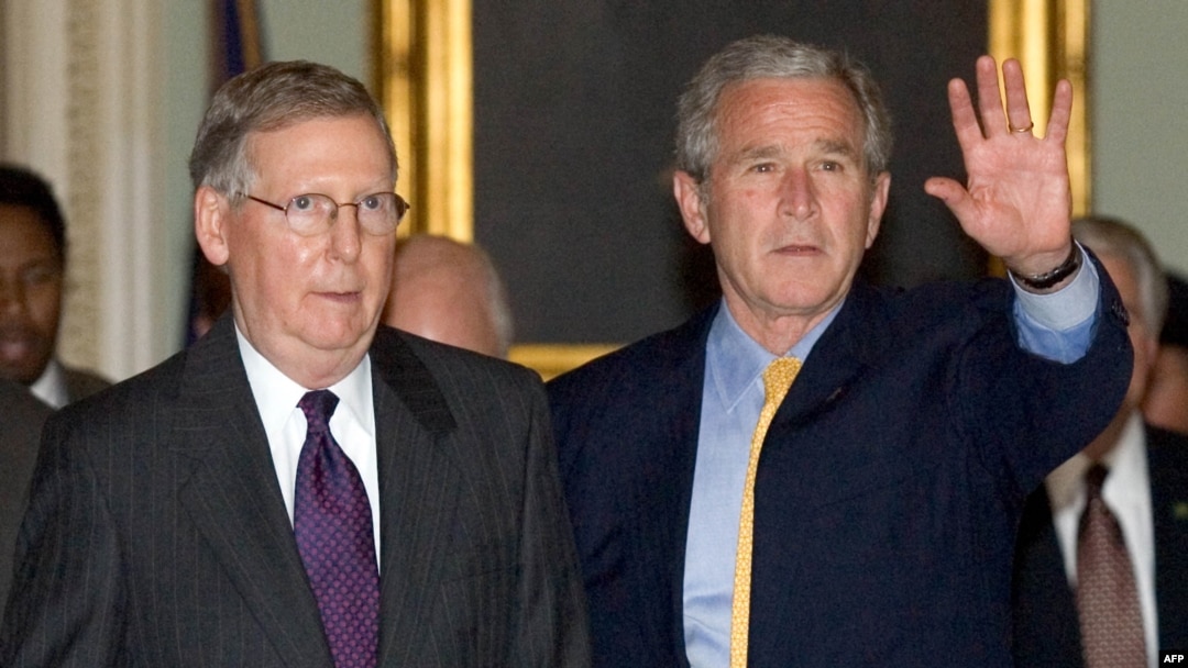 FILE - U.S. President George W. Bush walks with Senate Minority Leader Mitch McConnell after arriving at the Capitol for talks on an immigration reform bill in Washington, June 12, 2007. First elected in 1984, McConnell announced on Feb. 20, 2025, he would retire from the Senate.