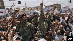Yemeni army officers lifted by anti-government protestors gesture as they join a demonstration demanding the resignation of of Yemeni President Ali Abdullah Saleh, in Sanaa, Yemen, April 24, 2011