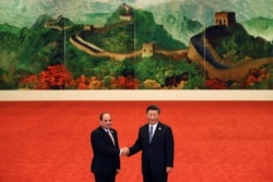 FILE - Egypt's President Abdel Fattah el-Sisi, left, shakes hands with Chinese President Xi Jinping during the Forum on China-Africa Cooperation held at the Great Hall of the People in Beijing, Sept. 3, 2018.