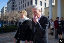 FILE- Special counsel Robert Mueller and his wife, Ann, depart St. John's Episcopal Church, across from the White House, in Washington, March 24, 2019.